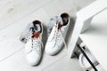 Sneakers with dirty socks on white wooden floor indoors Royalty Free Stock Photo
