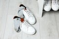 Sneakers with dirty socks on white wooden floor indoors Royalty Free Stock Photo