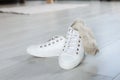 Sneakers with dirty socks on white wooden floor indoors Royalty Free Stock Photo