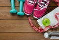 Sneakers dumbbells bottle of water apple and measure tape Royalty Free Stock Photo