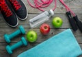 Sneakers dumbbells bottle of water apple and measure tape Royalty Free Stock Photo