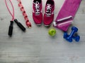 Sneakers dumbbells bottle of water apple and measure tape o Royalty Free Stock Photo