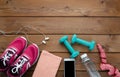 Sneakers dumbbells bottle of water and measure tape Royalty Free Stock Photo