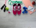 Sneakers dumbbells headphones bottle of water apple and skipping rope Royalty Free Stock Photo