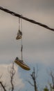 Sneakers hanging from overhead wires Royalty Free Stock Photo