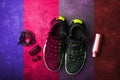Sneakers, headphones, water bottle. The concept of the sport of life in motion. Fashionable retro wave of bright paints