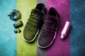 Sneakers, headphones, water bottle. The concept of the sport of life in motion. Fashionable retro wave of bright paints