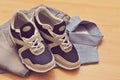 Sneakers, jeans with shirt, on wooden background