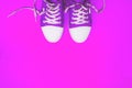 Sneakers with loose laces. Top view with copy space. Youth sneakers on a bright background. Royalty Free Stock Photo