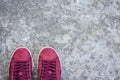 Sneakers of pink suede on the sidewalk