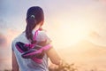 Sneakers on shoulder's woman to enjoy hiking and relaxing on mountain in sunrise Royalty Free Stock Photo