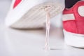 Sticky Situation: Red Sneakers Stuck in Chewing Gum