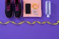 Sneakers, water bottle, towel, measuring tape mobile phone with headphones and fitness band Royalty Free Stock Photo
