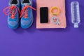 Sneakers, water bottle, towel, mobile phone with headphones and fitness band Royalty Free Stock Photo