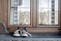Sneakers on window sill. Frontal perspective.