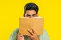 Sneaky cunning Indian man reading interesting fairytale story book, leisure hobby, learning, study