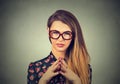 Sneaky, sly, scheming young woman in glasses plotting something Royalty Free Stock Photo