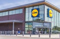 A person entering Lidl retail store wearing a face mask Royalty Free Stock Photo