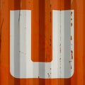 Sngle letter U on an orange corrugatedl background Royalty Free Stock Photo