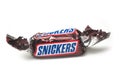 Snickers chocolate bar by Mars compagny in brown packaging on white background