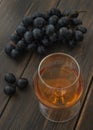 A snifter of cognac or brandy with a bunch of grapes Royalty Free Stock Photo