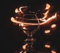 Snifter cognac glass and traces of a flame of fire in the dark Royalty Free Stock Photo