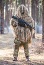 Sniper in camouflaged suit with rifle