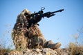 Sniper in ghillie suit with precision rifle with optic sight Royalty Free Stock Photo