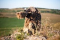 Sniper in ghillie suit with precision rifle with optic sight Royalty Free Stock Photo