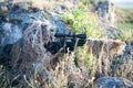 Sniper in ghillie suit with precision rifle with optic sight Royalty Free Stock Photo