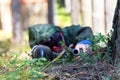 Sniper with paintball gun disguised in grass. Focus on top of ba