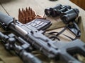 Sniper rifle, binoculars and ammunition on the wooden floor.