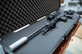 Sniper rifle with optical sight in case, gun shop