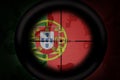 Sniper scope aimed at flag of portugal on the khaki texture background. military concept. 3d illustration
