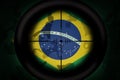 Sniper scope aimed at flag of brazil on the khaki texture background. military concept. 3d illustration