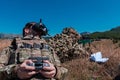 Sniper soldier assisted by an assistant to observe the area to be targeted with modern warfare tactical virtual reality