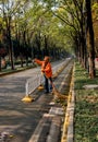 A snitation worker sweeping the road