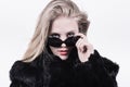 Snobbish upper class girl in dark sunglasses and fur Royalty Free Stock Photo