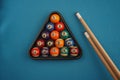 Snooker balls and cue on blue background. Billiard balls on the board. Pool table with rack of balls Royalty Free Stock Photo