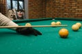 Snooker. close-up . male hands with cue playing billiards