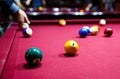 Snooker multicolored balls lay on the table. Closeup view. Billiard red table with cue and balls. Leisure, hobby, Royalty Free Stock Photo