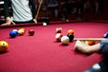 Snooker multicolored balls lay on the table. Closeup view. Billiard red table with cue and balls. Leisure, hobby, Royalty Free Stock Photo