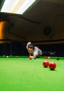 Snooker player placing the cue ball for a shot Royalty Free Stock Photo