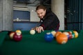 Snooker player placing the cue ball for a shot indoors Royalty Free Stock Photo