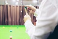 Snooker player standing waiting hold his cue Royalty Free Stock Photo