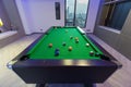 Snooker Pool Billiards green table with complete set of balls in a middle of a game in a modern games room Royalty Free Stock Photo