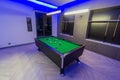 Snooker Pool Billiards room, green table with complete set of balls in a modern room with neon lights Royalty Free Stock Photo