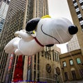 Snoopy balloon floats in the air during the annual Macy`s Thanksgiving Day parade along Avenue of Americas Royalty Free Stock Photo