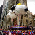 Snoopy balloon floats in the air during the annual Macy`s Thanksgiving Day parade along Avenue of Americas Royalty Free Stock Photo