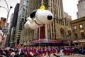 Snoopy balloon floats in the air during the annual Macy`s Thanksgiving Day parade along Avenue of Americas Royalty Free Stock Photo